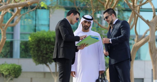 Businessmen standing talking to each other|-