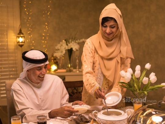 Mother serving mushroom soup to grandfather|-