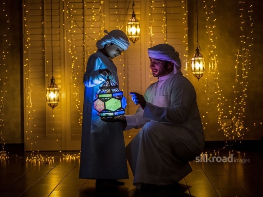 father and son enjoying lantern|-