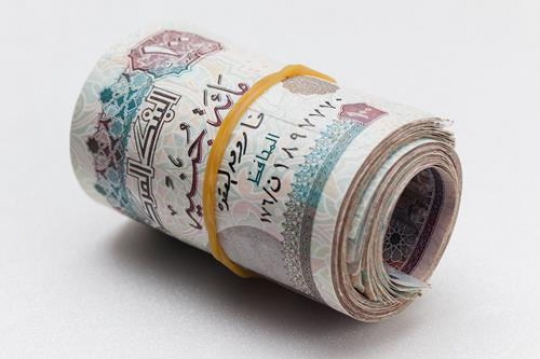 an egyptian money rolled up