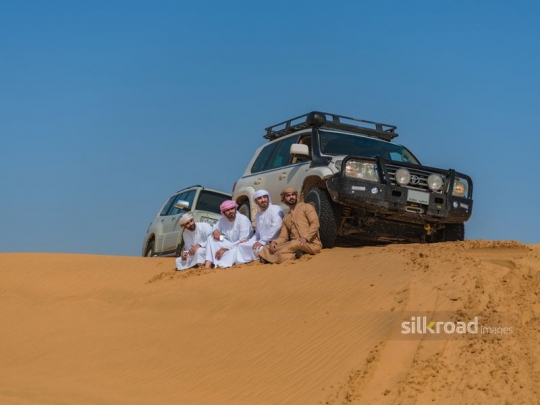 Guys hanging out in the desert