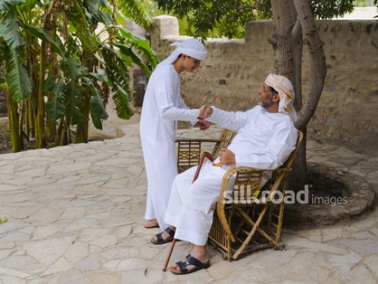 Teenager greeting grandfather|-