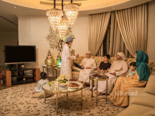 Son serving Arabic coffee|-