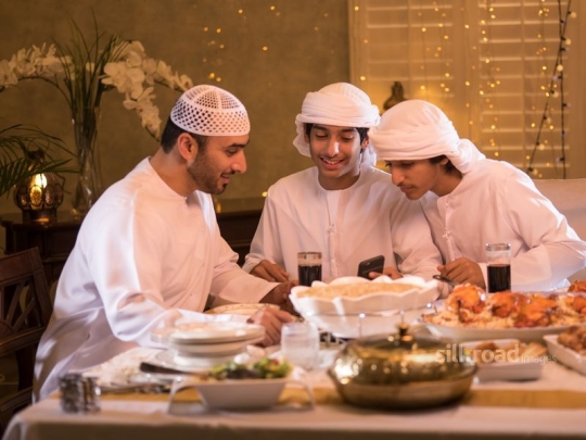 Boys with father checking phone|-