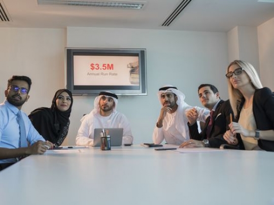 Colleagues sitting in the conference room during a meeting|-