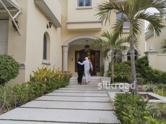 Arab man and woman walking outside together|