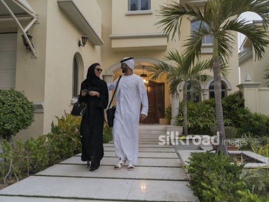 Middle Eastern man and woman walking together |