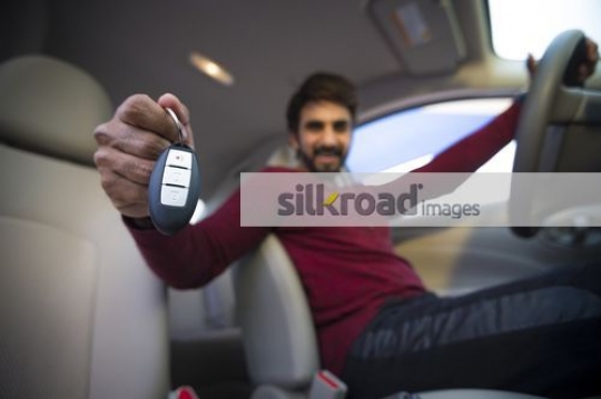 Young Expat sitting inside the car |