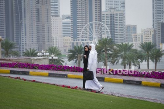 Business man and business woman talking to each other while walking to work|-