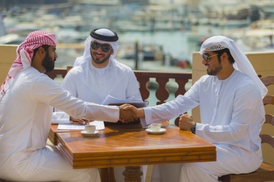 Arab business people shaking hands during a meeting|