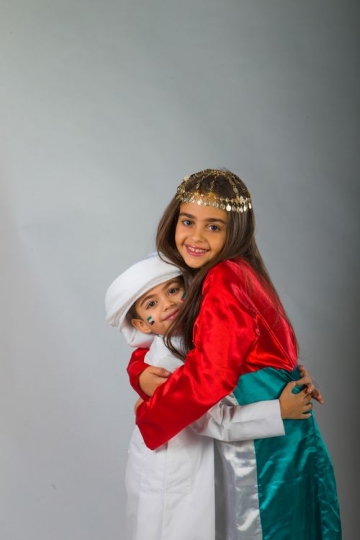 Young Middle Eastern siblings hugging each other