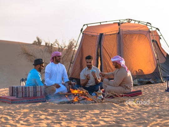 Friends playing cards in the desert camp