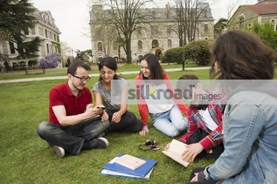 Group of friends sitting together on campus|