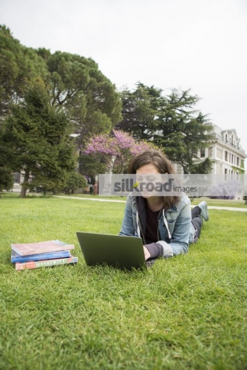 Woman using her laptop on campus|