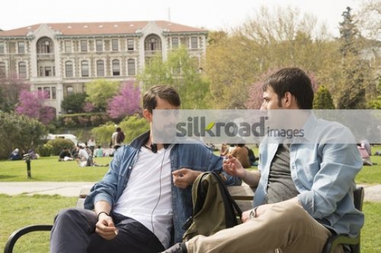Two friends sitting together talking|