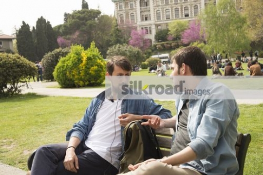 Two friends sitting together talking 