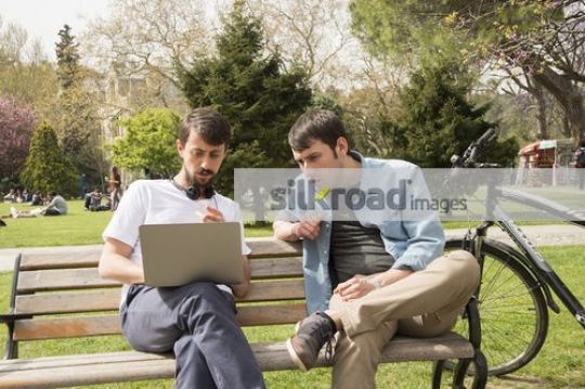 Two friends sitting together on the bench 