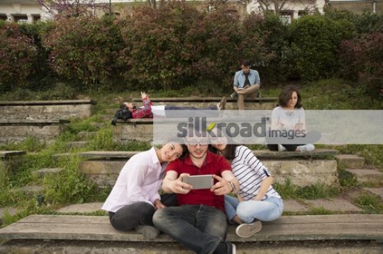 Friends sitting taking a selfie together|