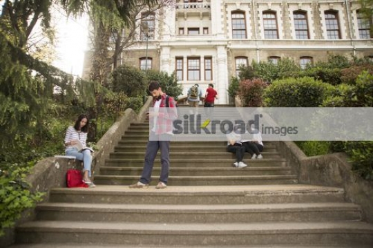 University Students scattered around the stair case|