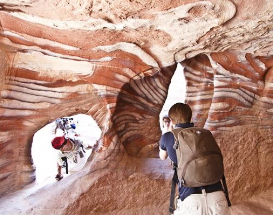 tourists with nabatean passage in petra,alkhazneh,siq canyon