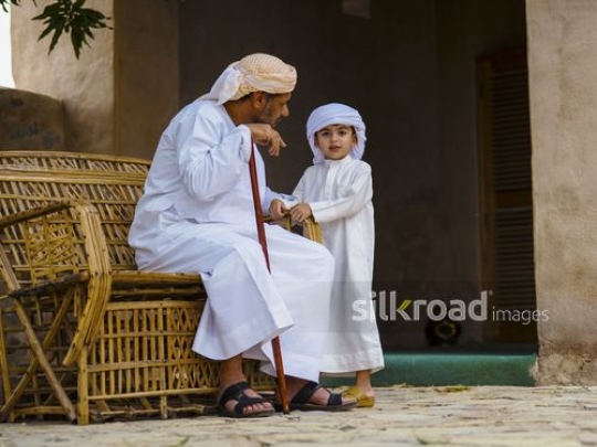 Boy talking with his grandfather|-