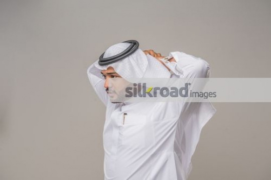 Arab man fixing his kandoura|