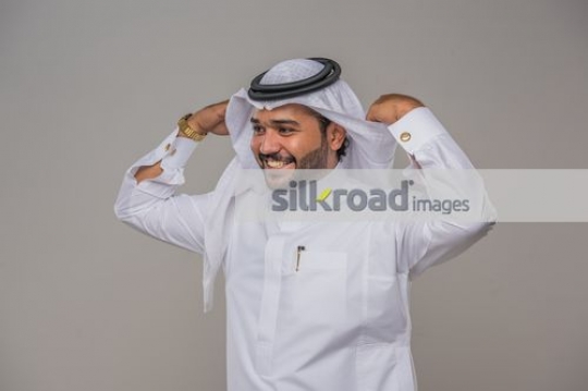 Arab man fixing his kandoura |