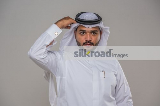 Middle Eastern man fixing his kandoura|