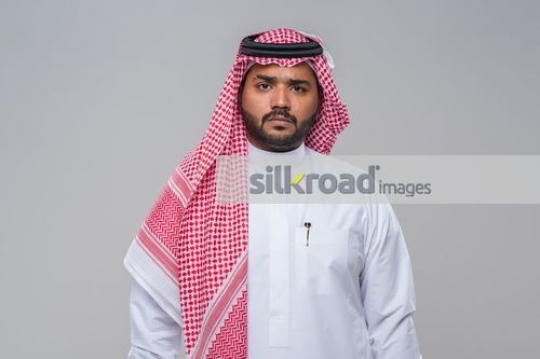 Middle Eastern Businessman dressed in the traditional attire|