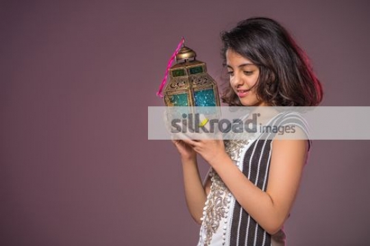 Arab girl looking at the Ramadan Lantern|