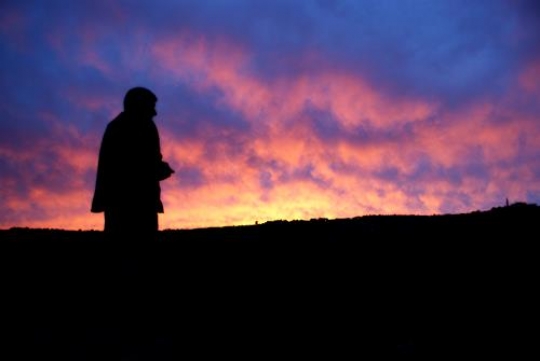 silhouetteof man looking into the horizon