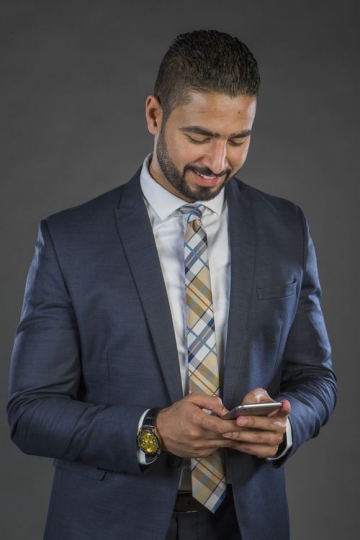 An Arab Businessman Texting on Mobile|-