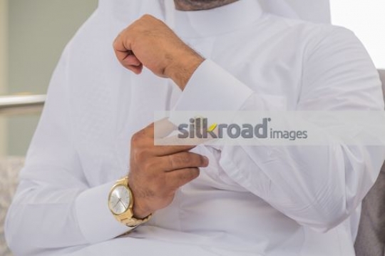 Man fixing the cufflink |