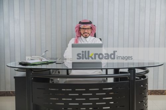 Businessman sitting at the office desk|