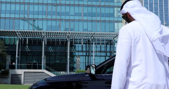 Middle Eastern Businessman closing the door walking away from his car|-