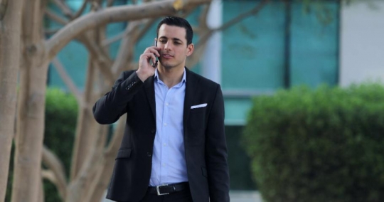 Middle Eastern Businessman talking on the phone|-