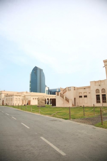 neighbourhood area with a skyscraper in the background