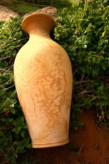 close up of a clay vase on grass