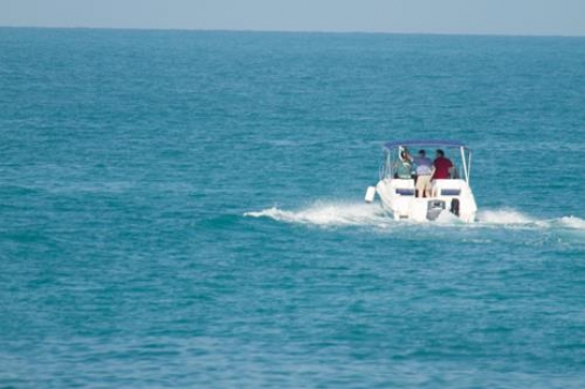 people in a boat across the sea