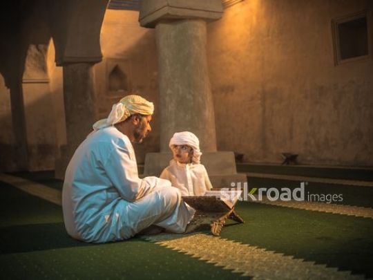 Old man educating islamic values to grandson|-