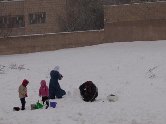 family enjoying in snow and winter