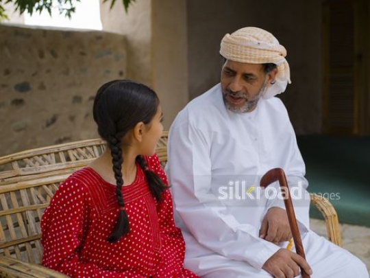 Girl in conversation with grandfather|-