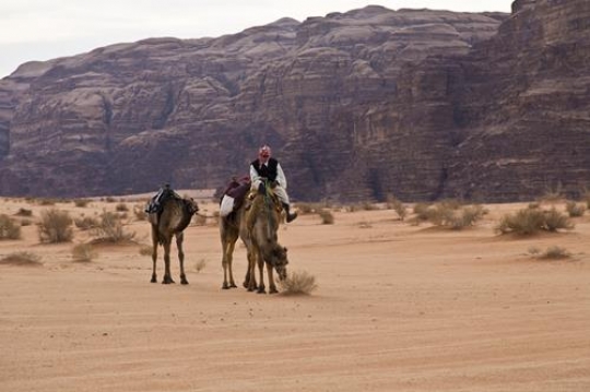 Bedouin and three camels in Wa