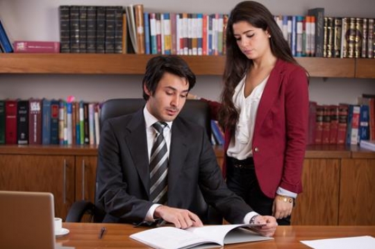 Boss Discussing Report with Female Employee