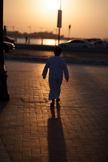 kid walking on side walk