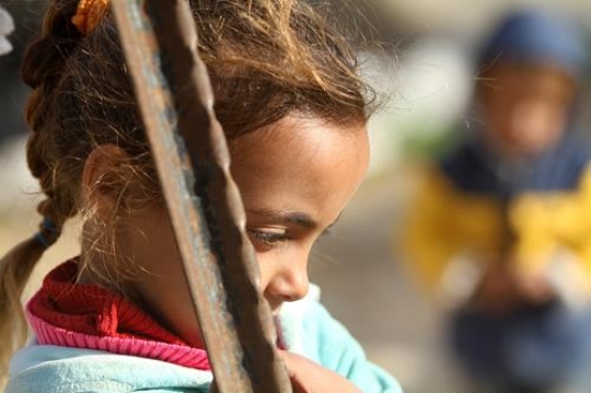Cute little girl is playing with her brothers.