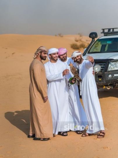 Friends taking selfie with falcon