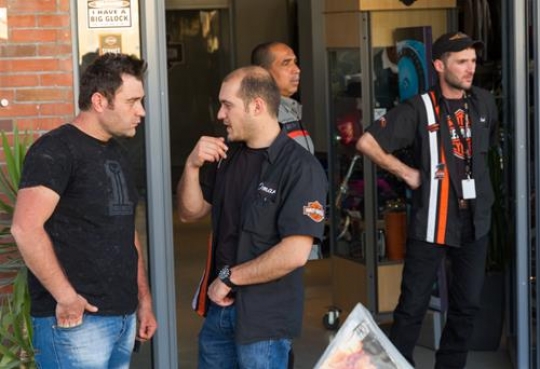 two men standing outside chatting 