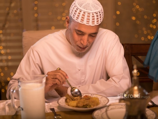 Old man eating traditional meal|-