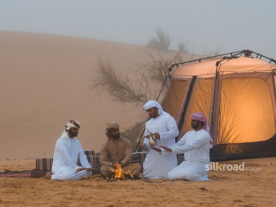 Man serving arabic coffee